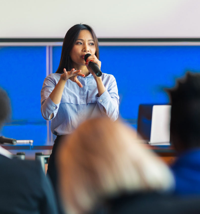 Female speaker talking at a conference